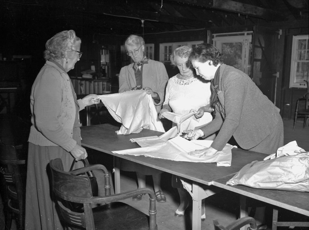 Women examining documents at a table